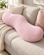 Pink Snuggi Body Align pillow on bed